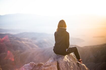 people, nature, woman, travel, adventure, trek, mountain, rock, sunset, cliff, black, hoodie, jacket, alone, thinking, freedom