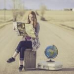 globe trotter, traveller, globe, map, journey, planning, waiting, female, woman, world, road, dirt road, travel, traveling, world map, outdoors, young woman